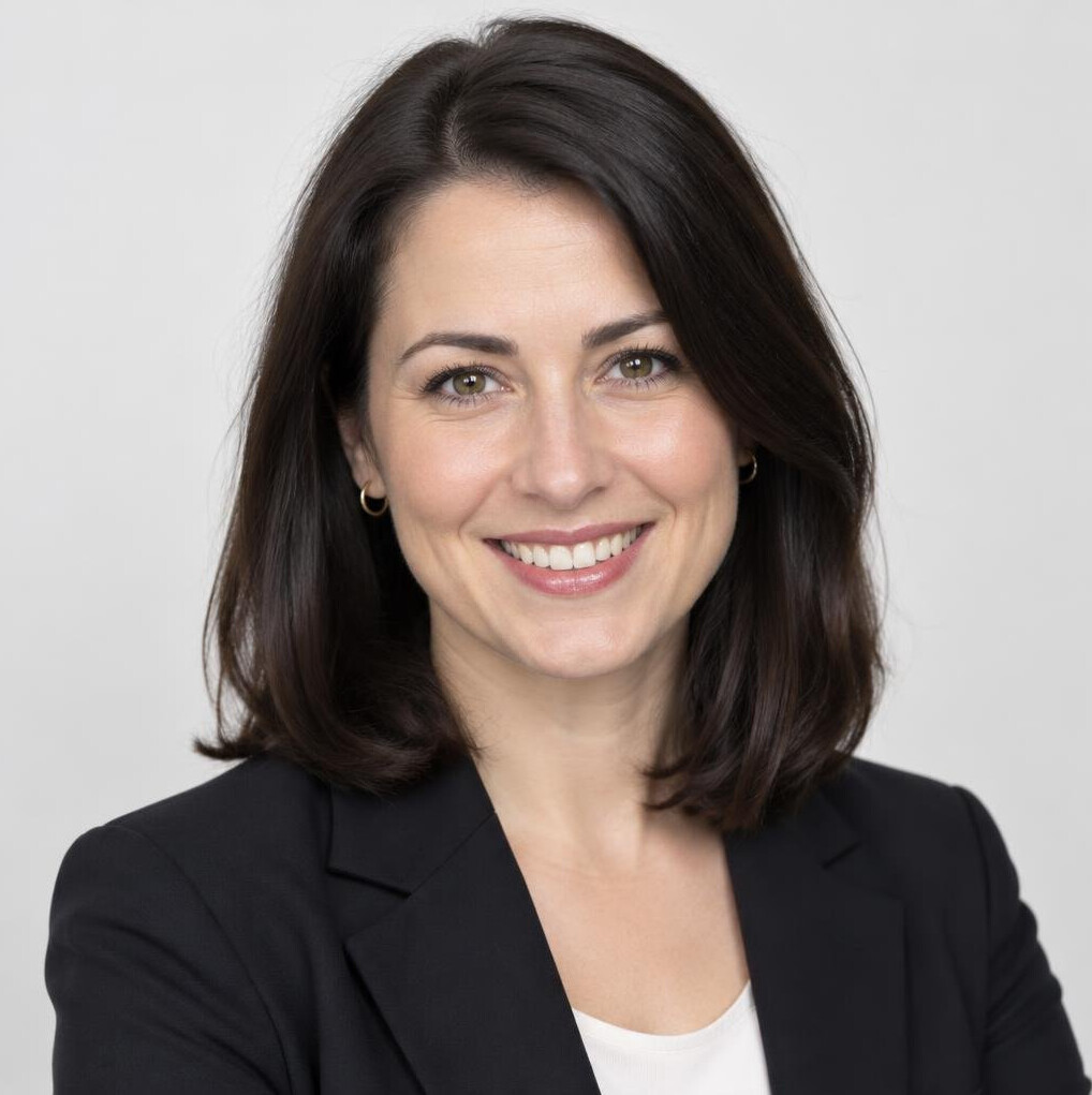 Smiling professional woman with dark hair in a blazer