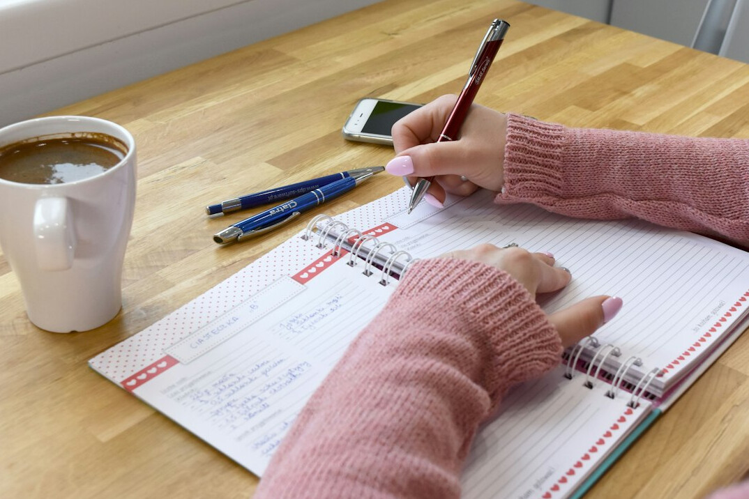 person tracking expenses on notebook
